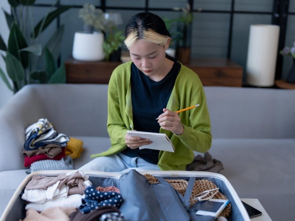 Travel checklist with passport and notebook before packing for a week