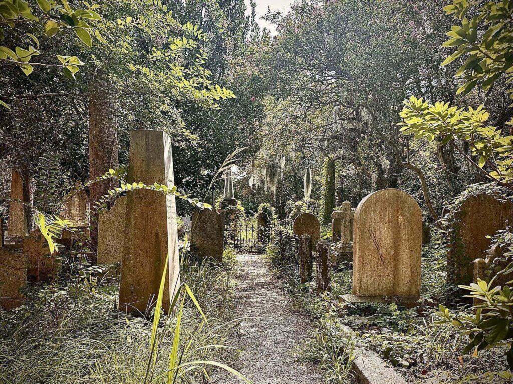 Historic Unitarian Church graveyard with moss-covered oak trees in Charleston
