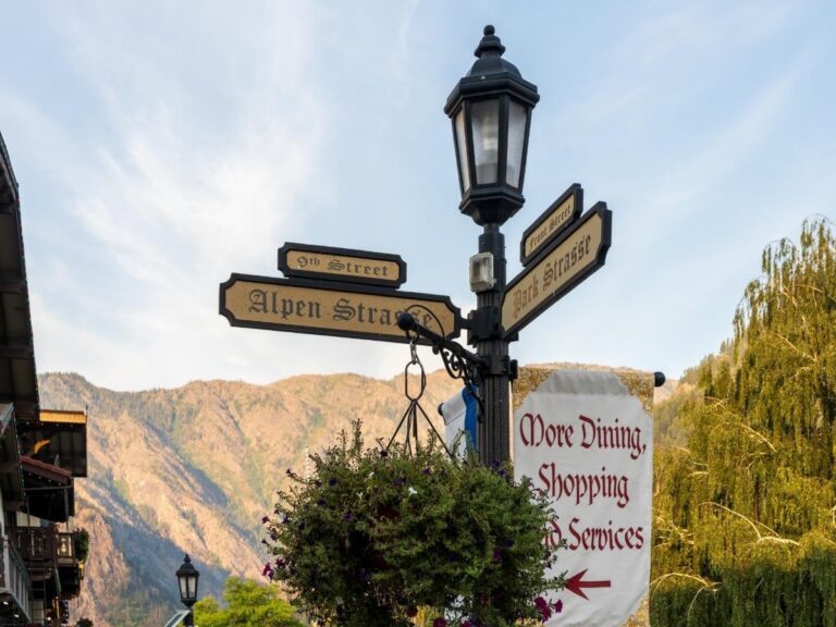 Bavarian-style buildings with flower boxes in Leavenworth Washington with Cascade Mountains in background