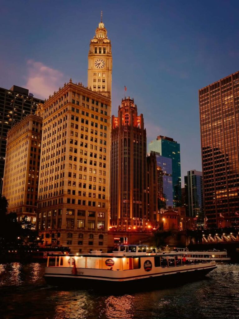 Wrigley Building illuminated at night along the Chicago River