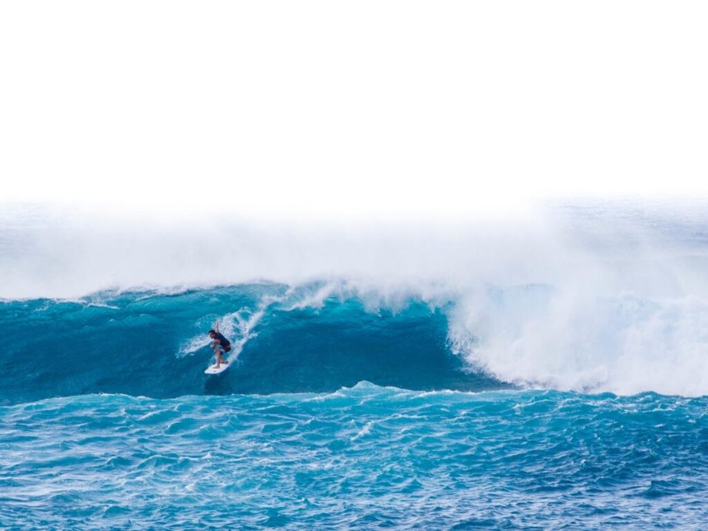 Surfers riding waves at Banzai Pipeline on the North Shore of Oahu
