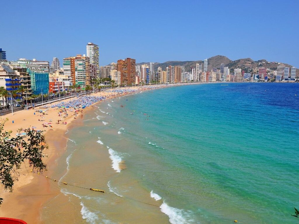 Levante Beach in Benidorm Spain with tourists enjoying the shore
