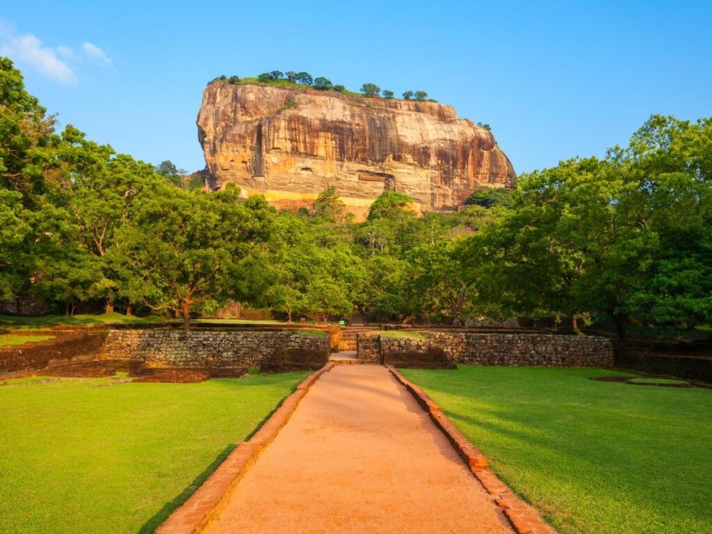 Sigiriya Rock Fortress rising above jungle in Sri Lanka at sunrise
