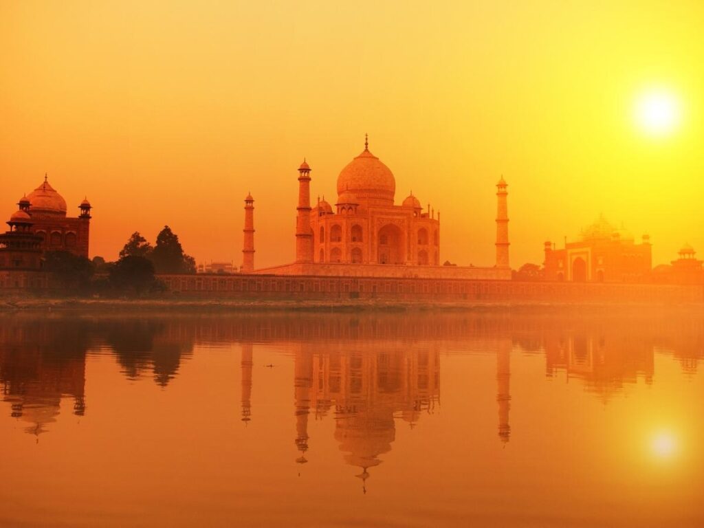 Taj Mahal at sunrise reflected in water Agra India