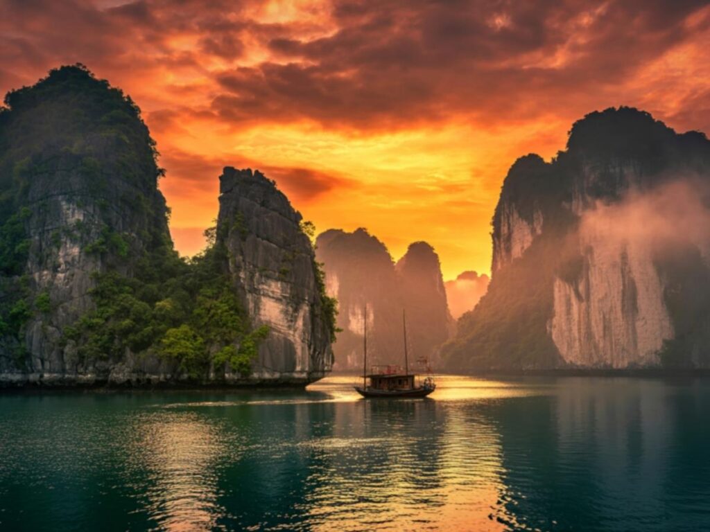 Ha Long Bay limestone karsts reflected in calm water Vietnam