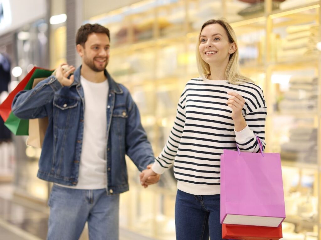 Tourists dressed modestly walking in Dubai mall following local dress code guidelines