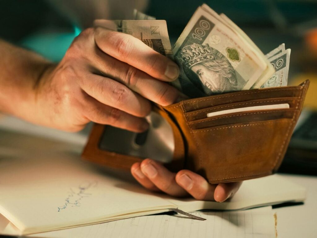 Traveler counting local currency cash from a wallet while on vacation