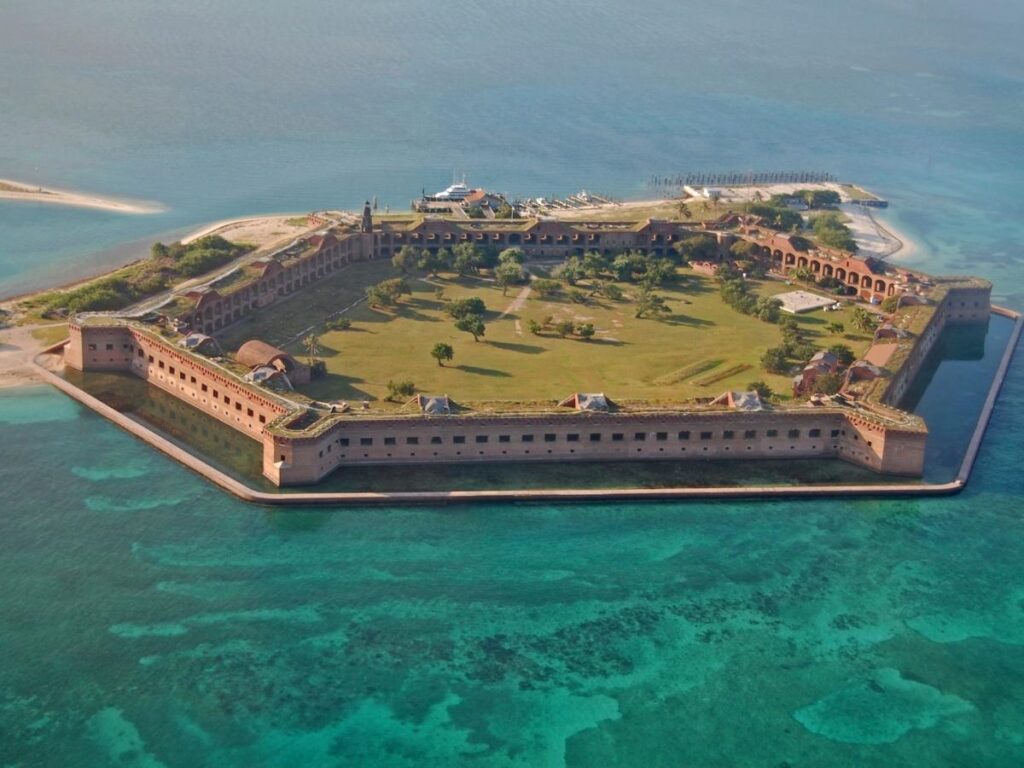 Crystal clear turquoise waters and white sand beach at Dry Tortugas National Park with Fort Jefferson