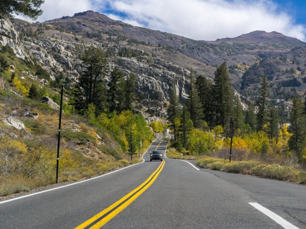 Highway 49 winding through the golden Sierra Nevada foothills in California's Gold Country on a warm autumn day