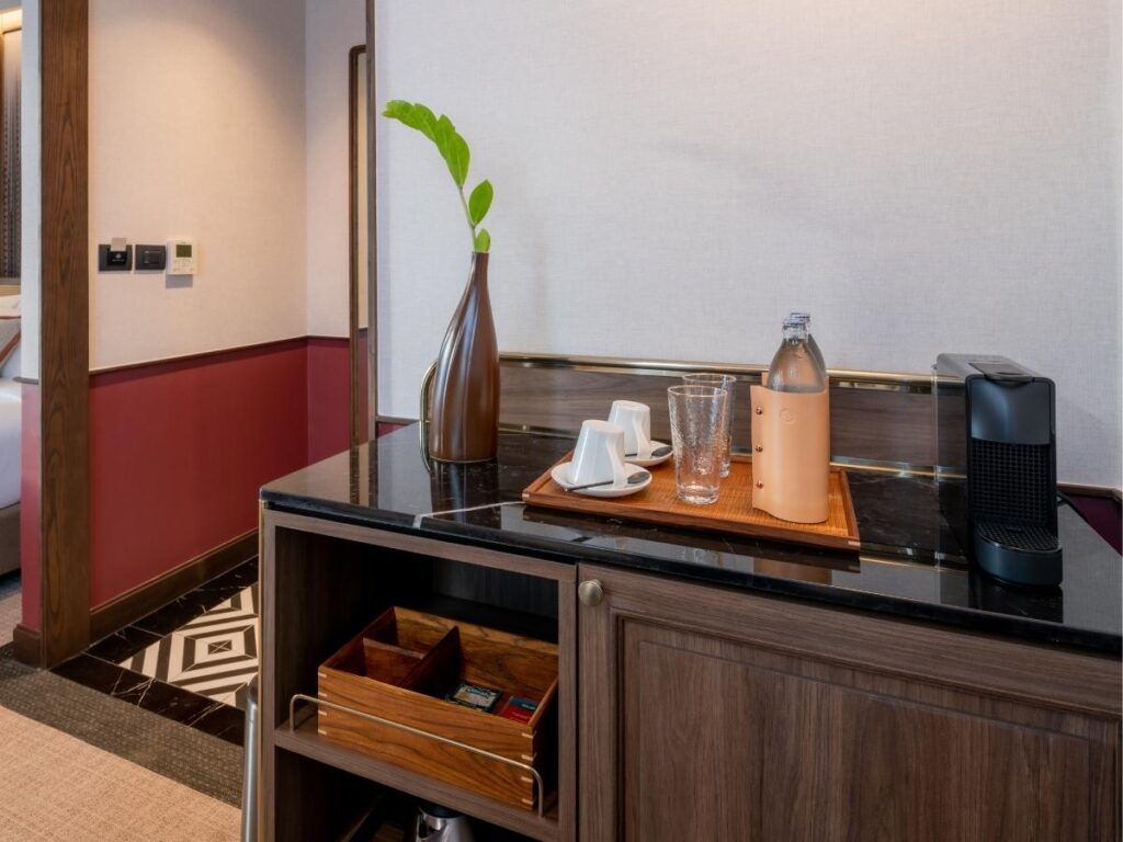 Hotel room drinking glasses on bathroom counter next to sink in luxury hotel