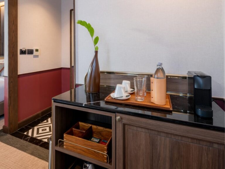 Hotel room drinking glasses on bathroom counter next to sink in luxury hotel