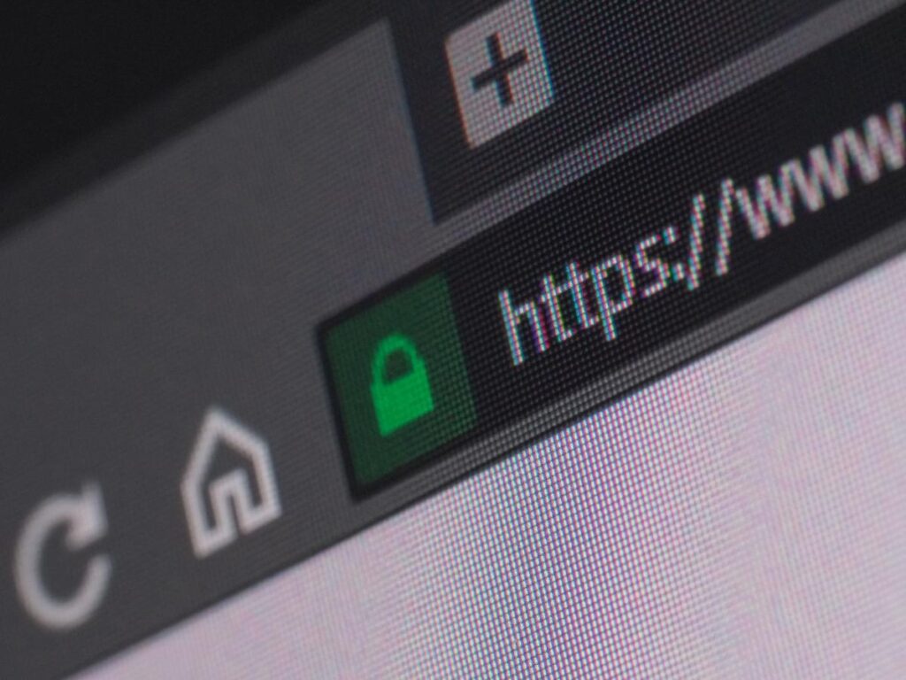 Close-up of a browser address bar showing a padlock icon and https on a secure website on a laptop screen