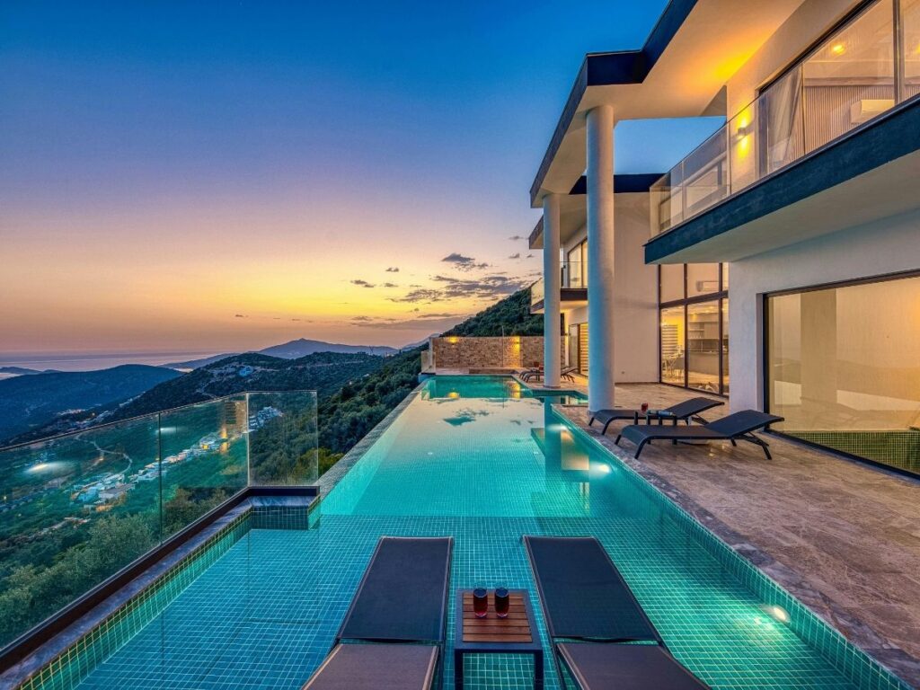 Luxury hotel pool area with private cabanas and lounge chairs