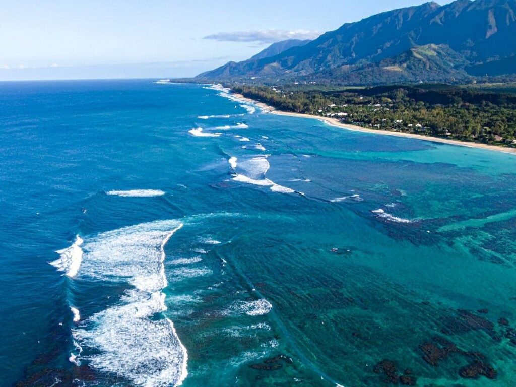 Aerial view of Oahu island coastline showing beaches and mountains in Hawaii