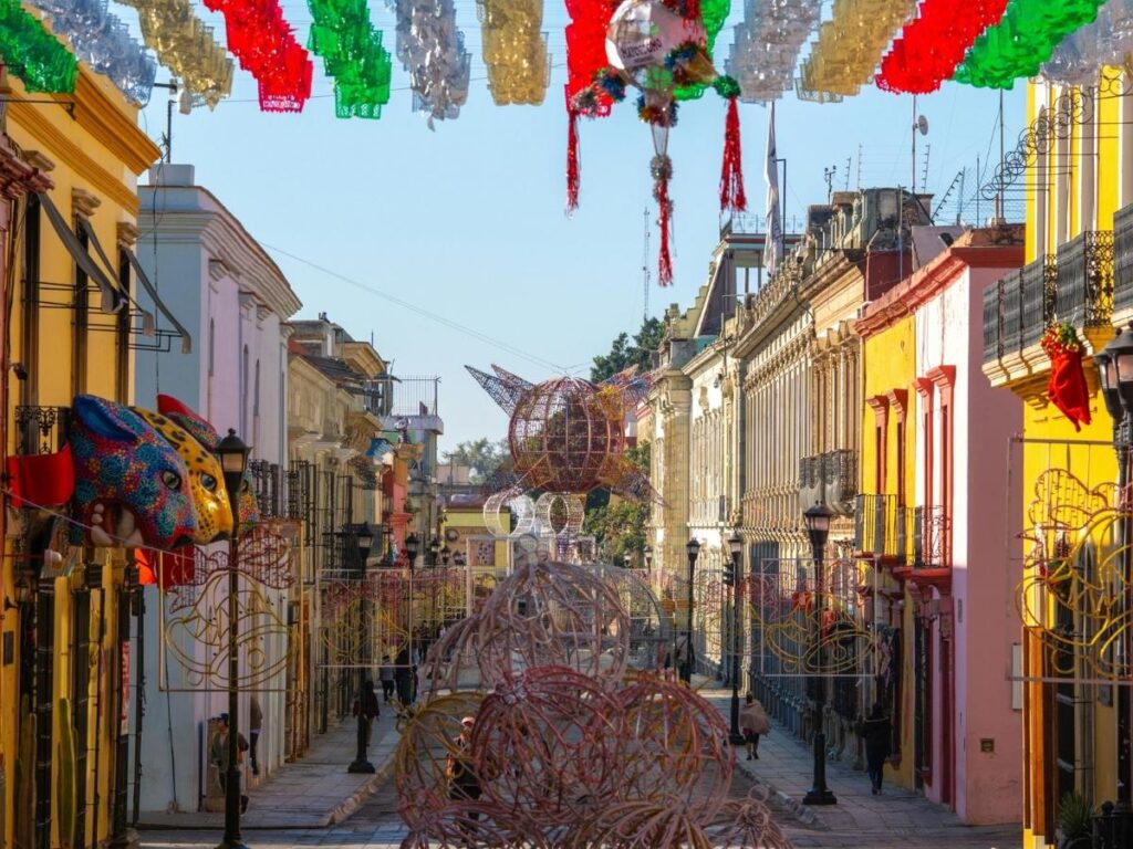 Colorful colonial street in Oaxaca Mexico with local market stalls and traditional architecture on a sunny day