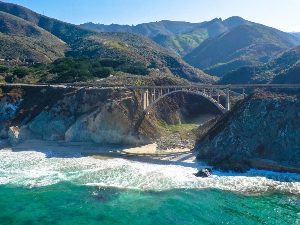 Bixby Creek Bridge on the Pacific Coast Highway in Big Sur California with dramatic cliffs and the blue Pacific Ocean in the background