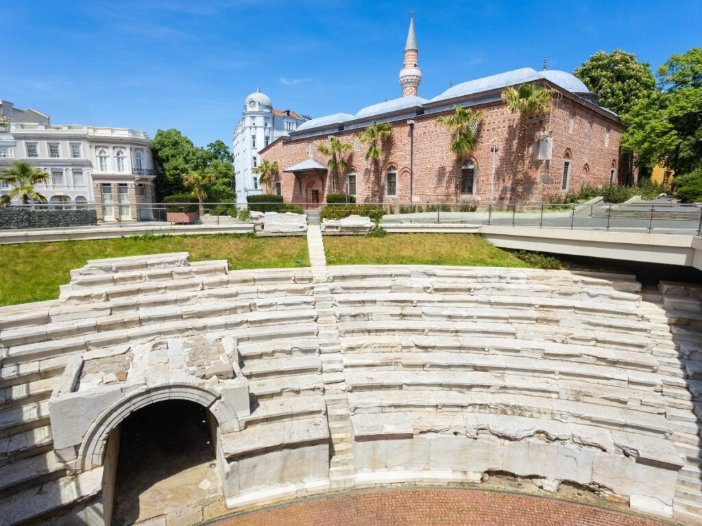 Ancient Roman amphitheatre in the old town of Plovdiv Bulgaria surrounded by colorful painted merchant houses