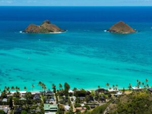 Turquoise waters and white sand at Lanikai Beach, Oahu, Hawaii with Mokulua Islands in background