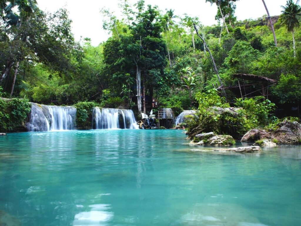 Turquoise tiered pools at Cambugahay Falls in Siquijor Philippines surrounded by lush tropical greenery