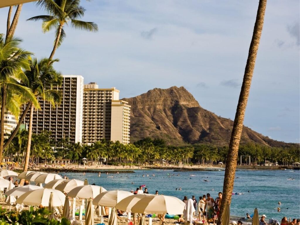 Quiet street near Waikiki Beach with local hotels and palm trees