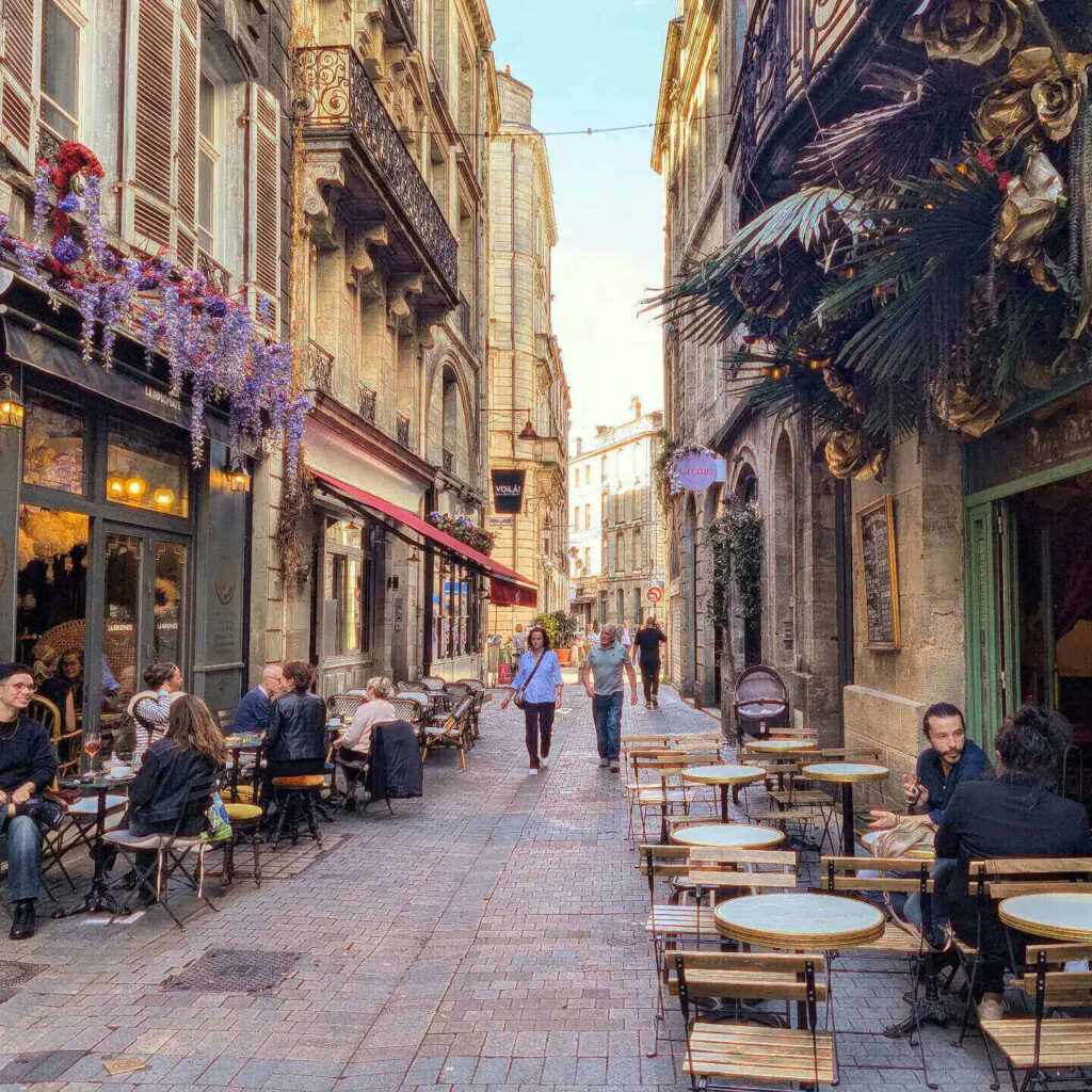 People sitting at outdoor cafes enjoying a relaxed afternoon in Bordeaux