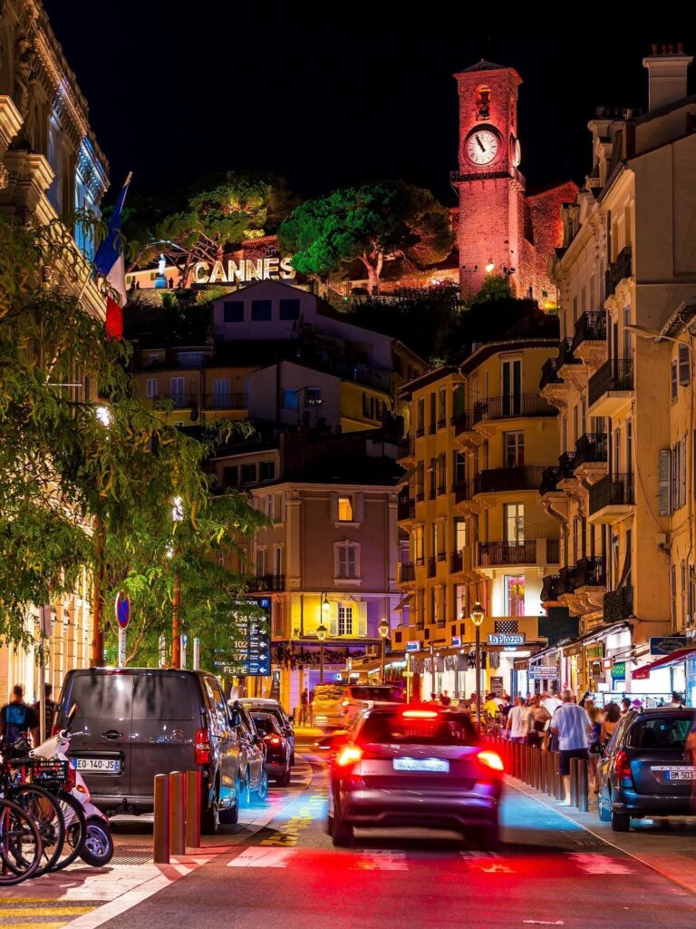 Evening atmosphere in Cannes with lights along the promenade