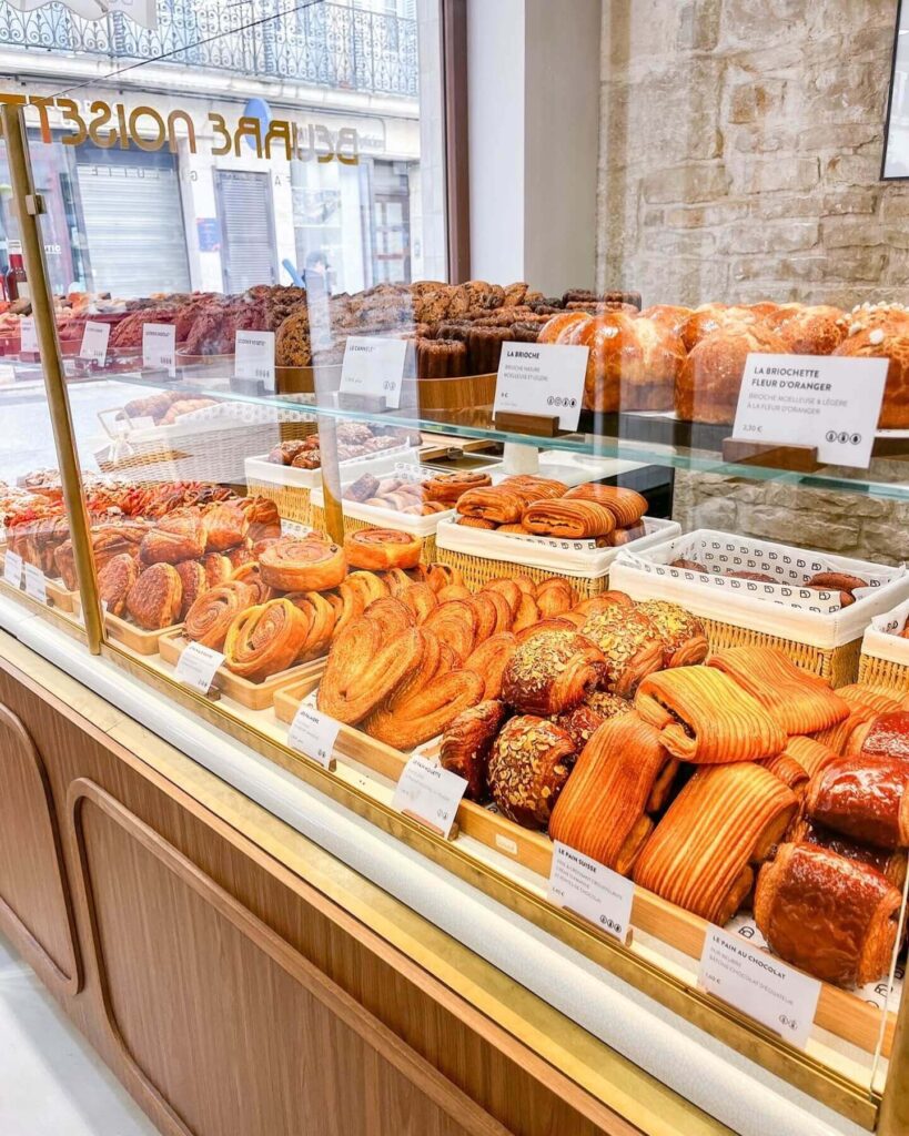 Fresh pastries and bread in a bakery window in Dijon
