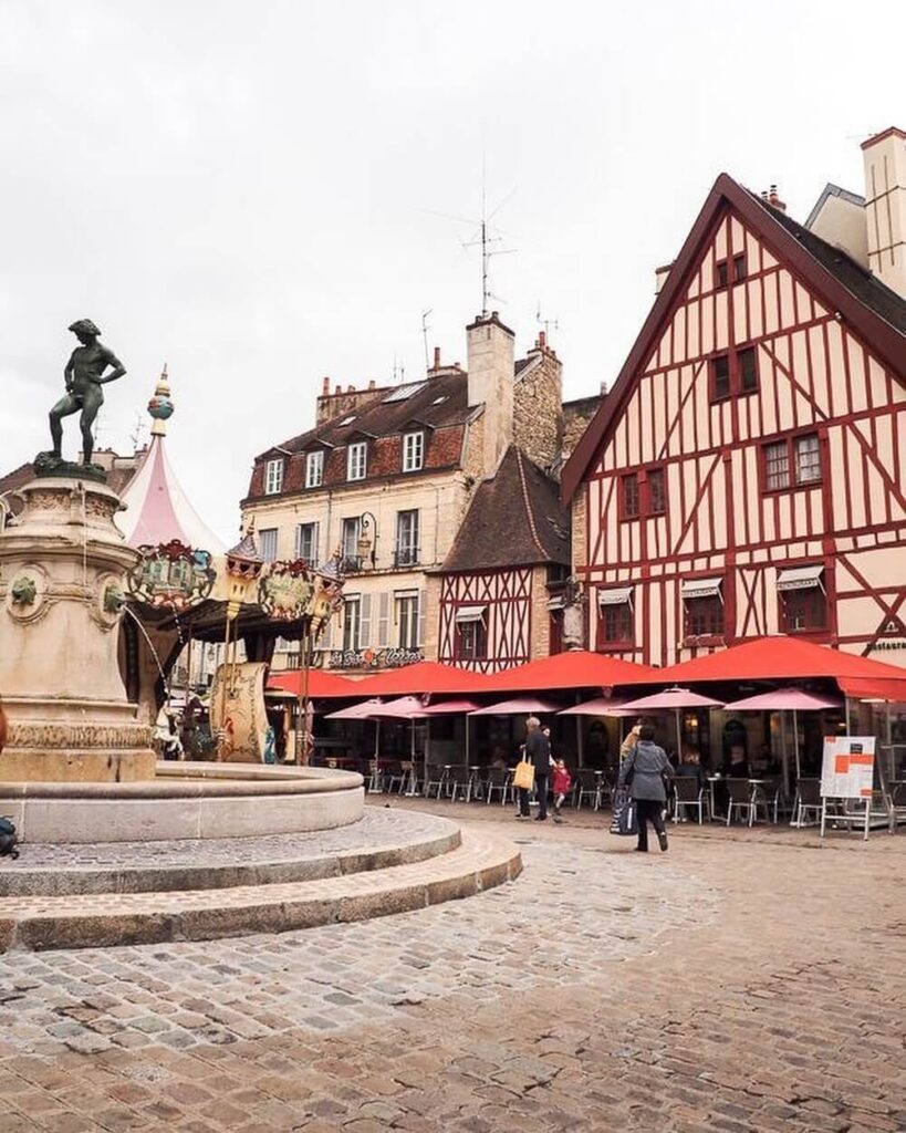 Walking through narrow streets in Dijon Old Town with historic buildings