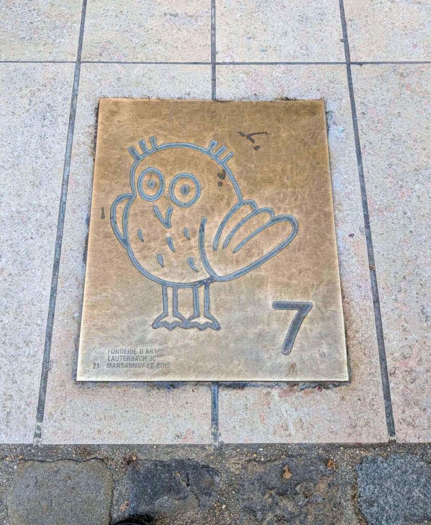 Owl Trail marker on the ground in Dijon guiding walking route