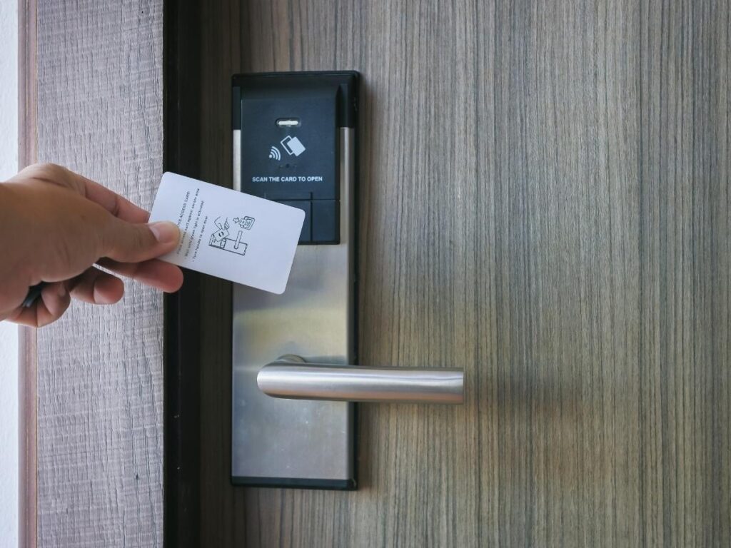 Hotel room keycard photographed next to a room number plate on a hotel door