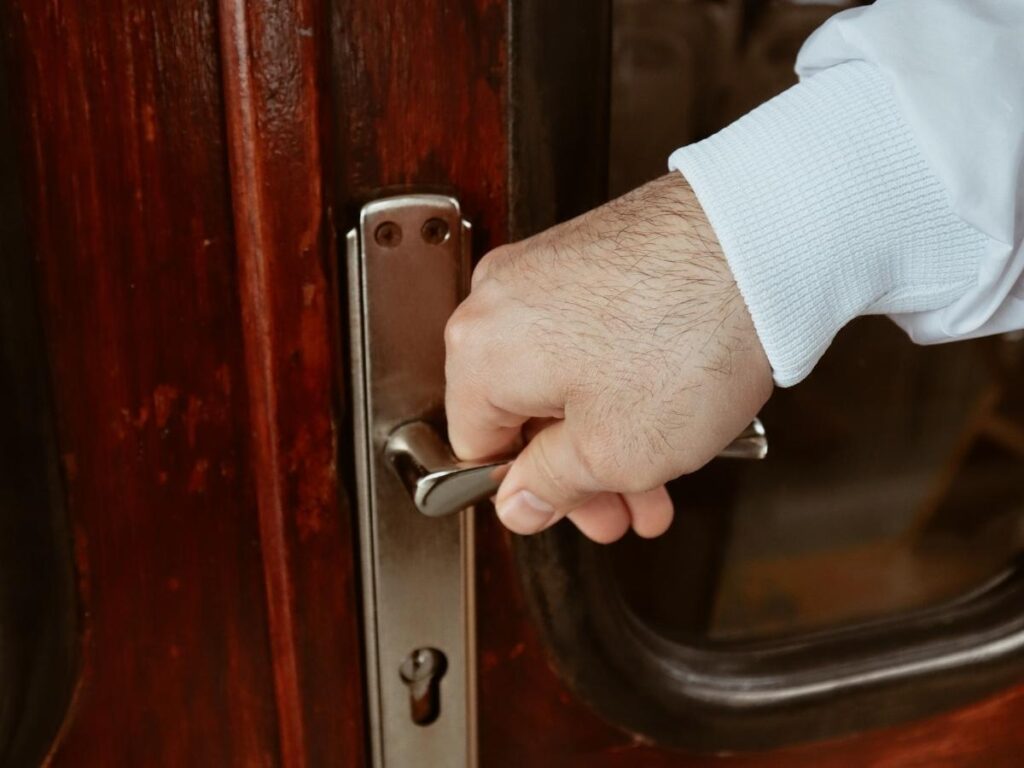 Close up of a hotel room door with deadbolt and security latch locked at night