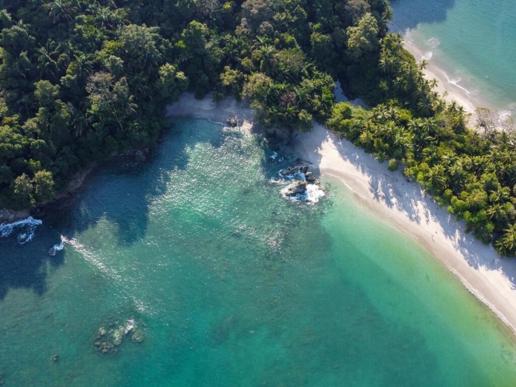 Lush tropical rainforest meeting a white sand beach at Manuel Antonio National Park Costa Rica