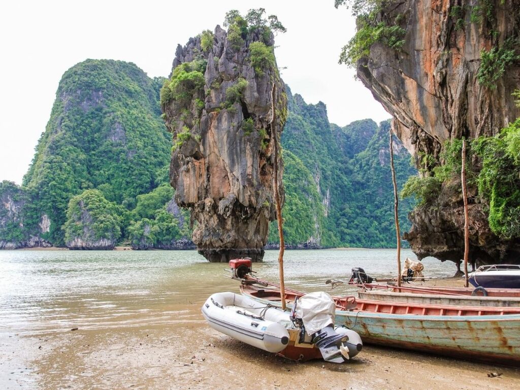 Turquoise bay and limestone cliffs of Phang Nga Bay seen from a boat in Phuket Thailand