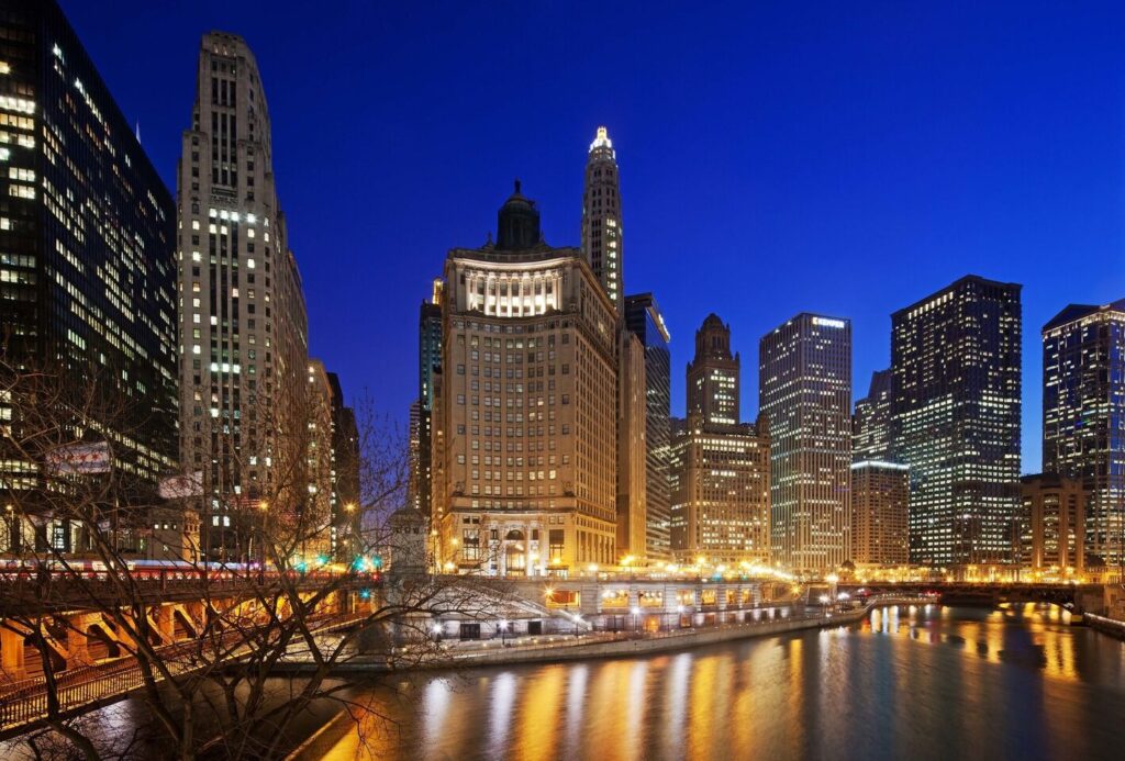 River and skyline view from LondonHouse Chicago featuring the Chicago River, historic bridges, and downtown skyscrapers at sunset