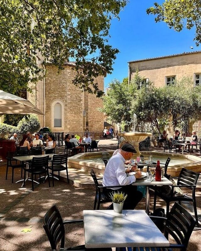 Relaxed café scene in Montpellier with people sitting outside