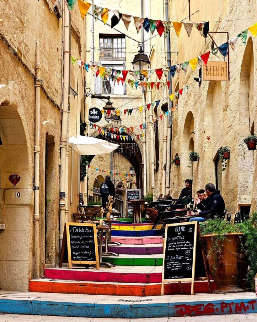 Everyday street life in Montpellier with students and locals at cafés