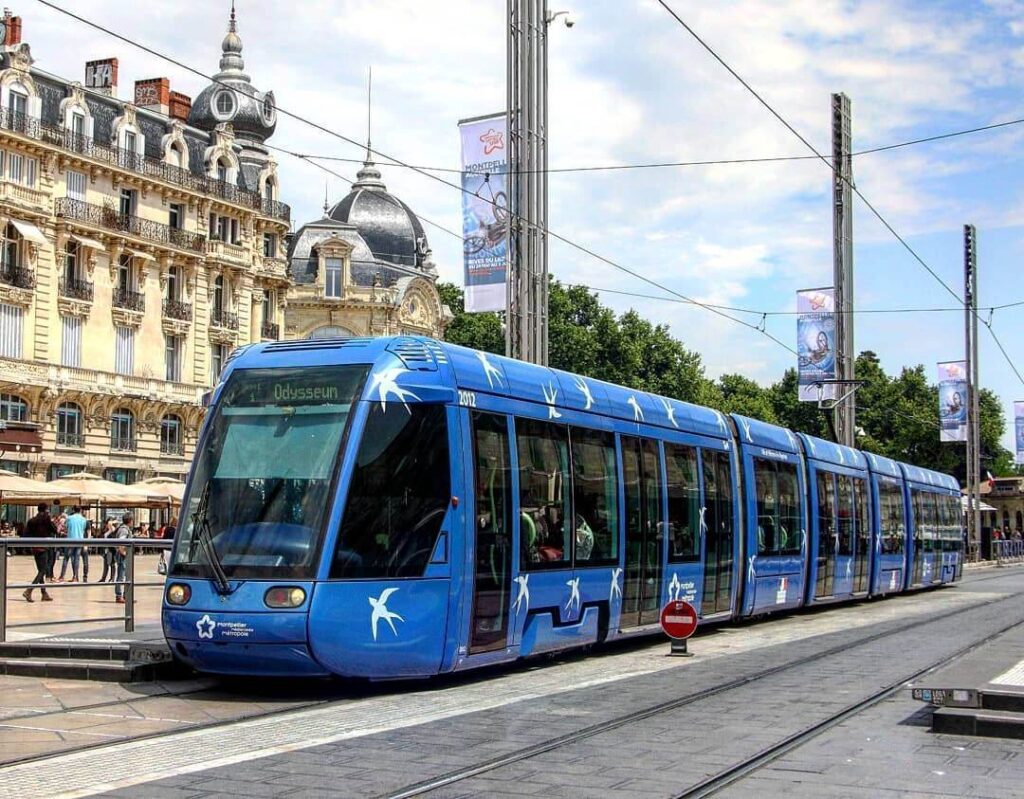 Tram moving through Montpellier city center with pedestrians