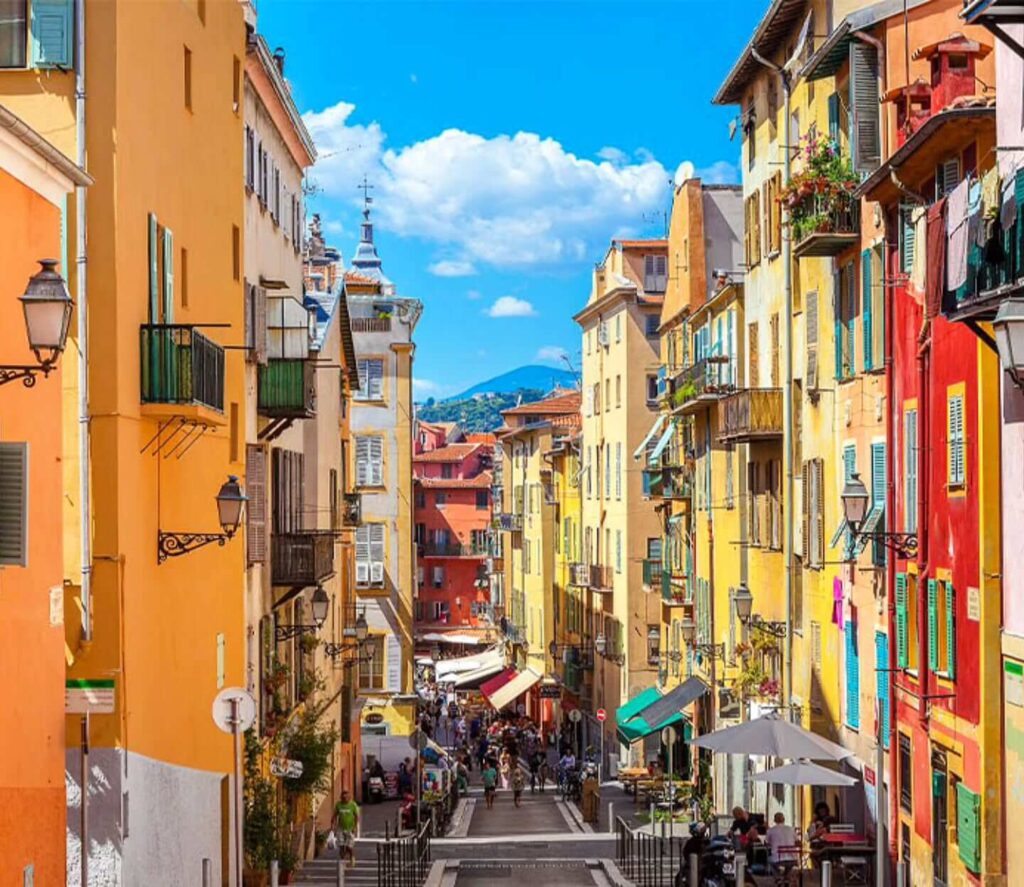 Walking through narrow streets of Old Town Nice during the day