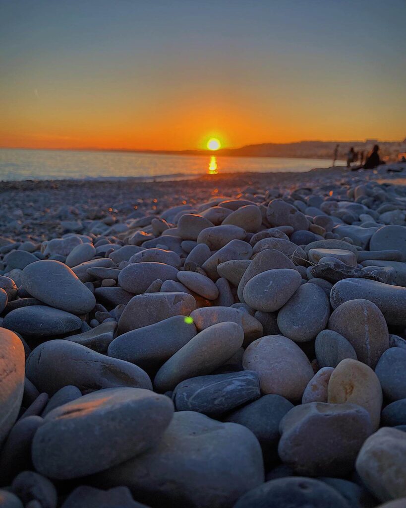 Pebble beach in Nice with clear blue Mediterranean water