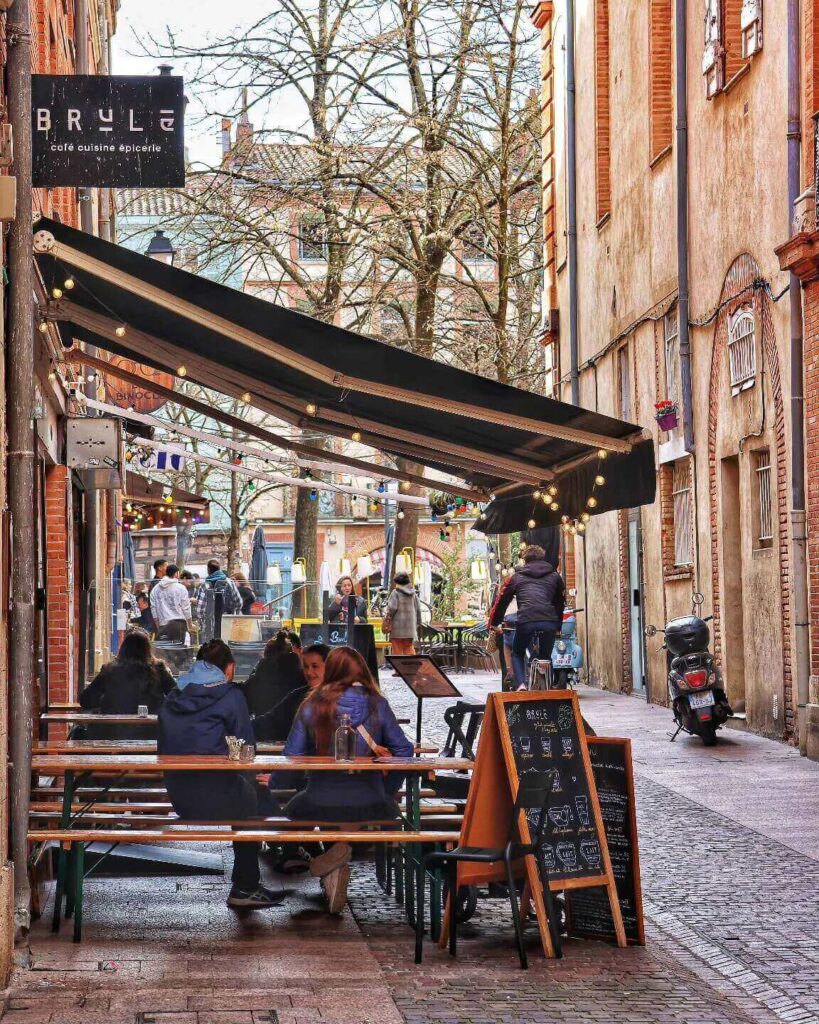 People relaxing at an outdoor café in Toulouse during a quiet morning