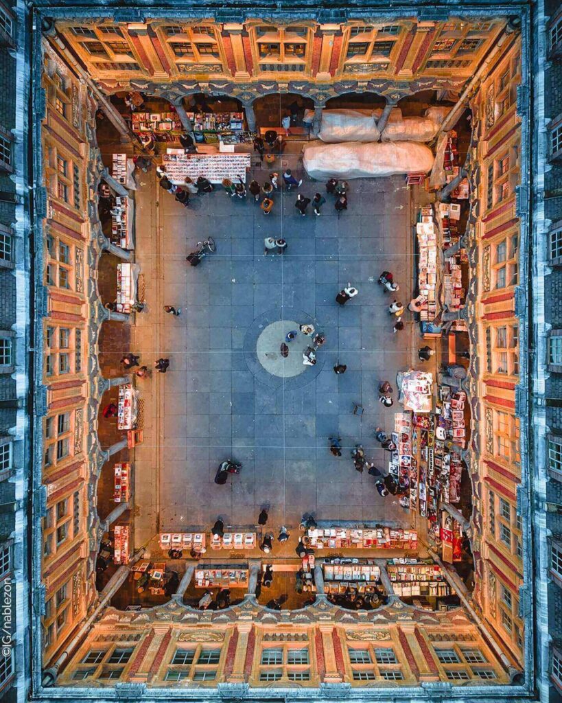 Courtyard of Vieille Bourse Lille with book stalls and people