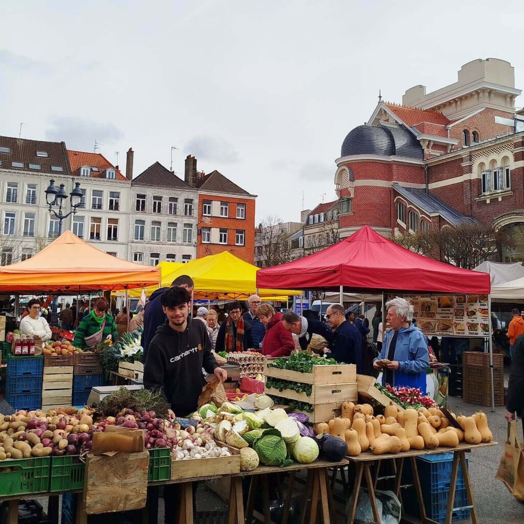Busy Wazemmes market in Lille with local vendors and food stalls