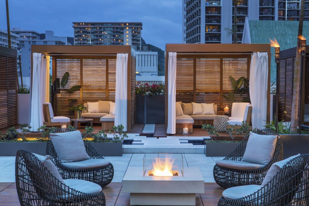 Exterior view of 'Alohilani Resort Waikiki Beach in Waikiki, featuring modern beachfront design, ocean views, infinity pool deck, and vibrant tropical resort atmosphere.