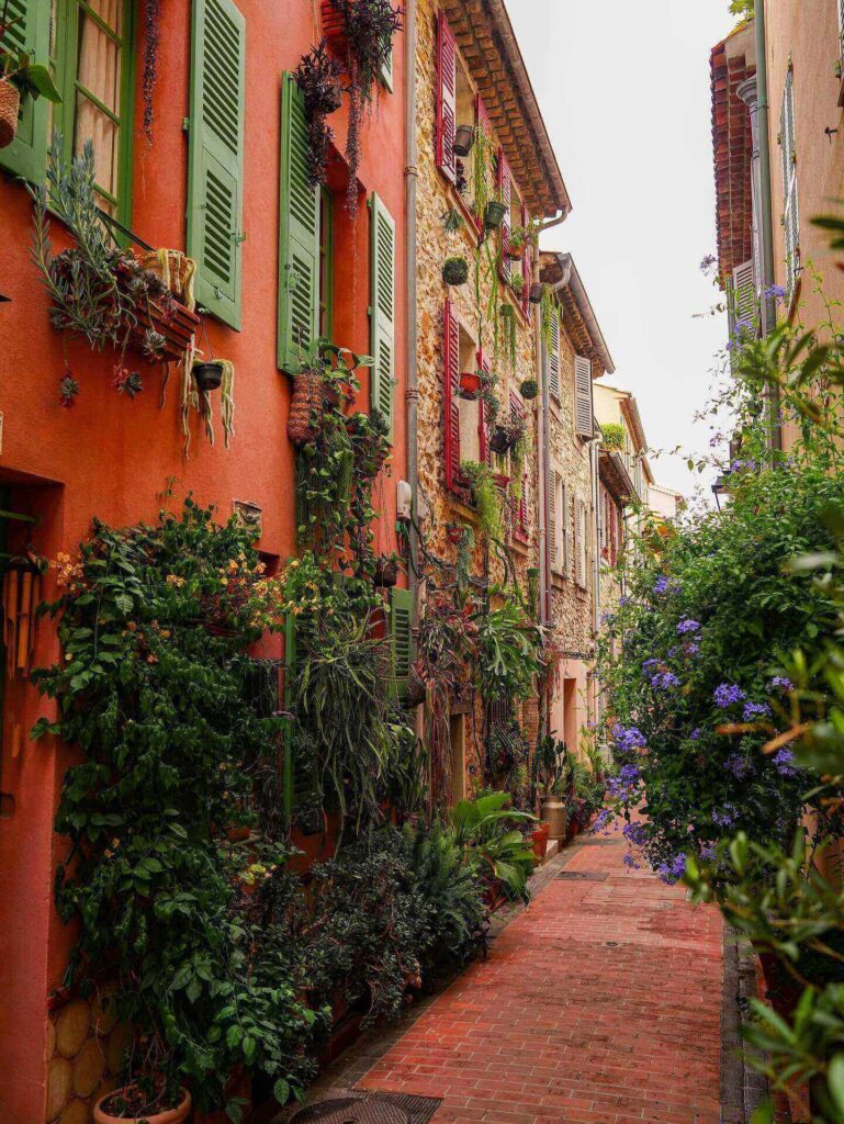 Narrow streets in Antibes Old Town with pastel buildings and shutters