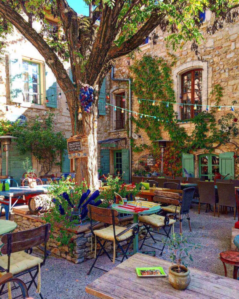 Outdoor café in Avignon with tables set in a quiet street