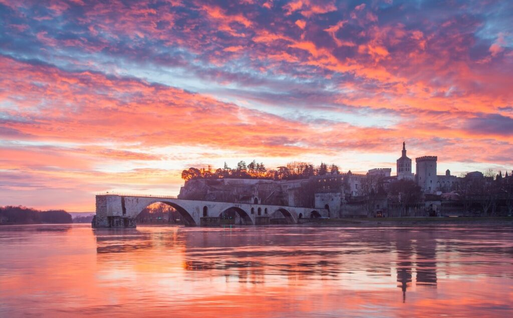 Sunset view over Avignon with Rhône River and historic skyline