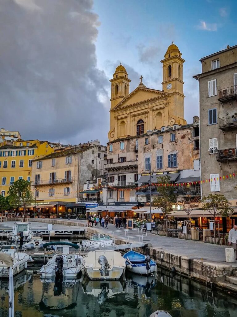 Overview of Bastia Old Port with colorful buildings and boats along the harbor