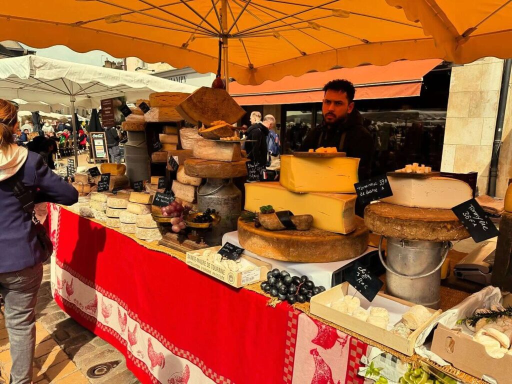Local food stalls with cheese and bread at Beaune market