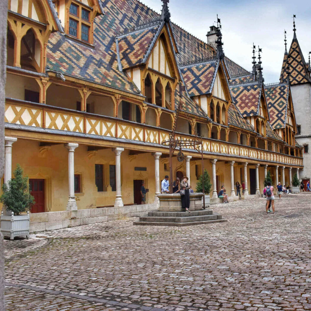 Busy summer street in Beaune with visitors and cafes