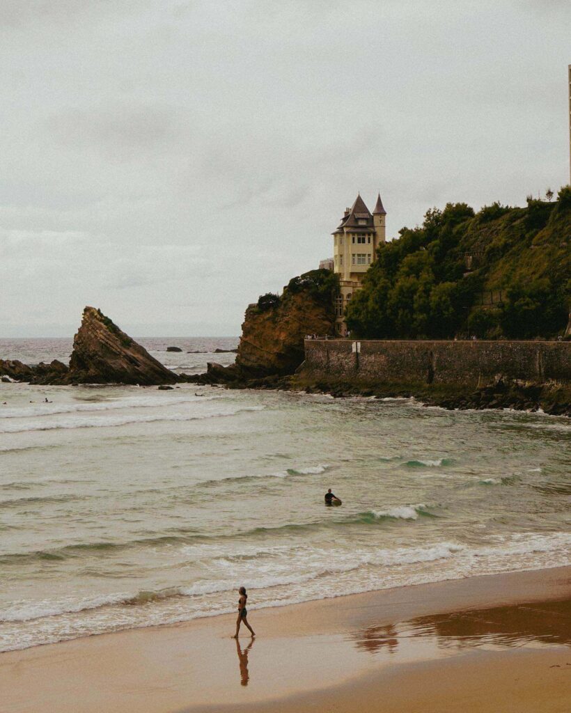 Biarritz coastline with ocean waves and town buildings along the shore